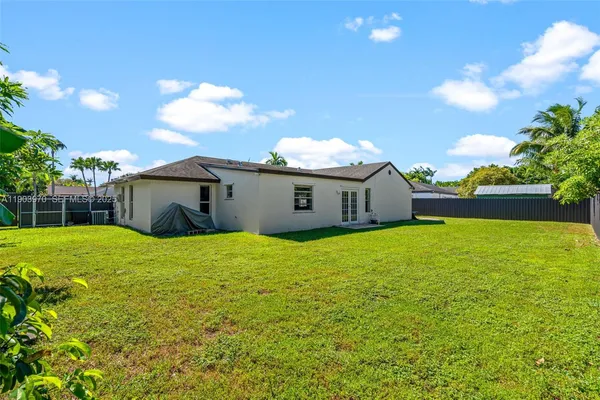 a view of backyard of house with green space