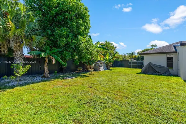 a backyard of a house with lots of green space and garden