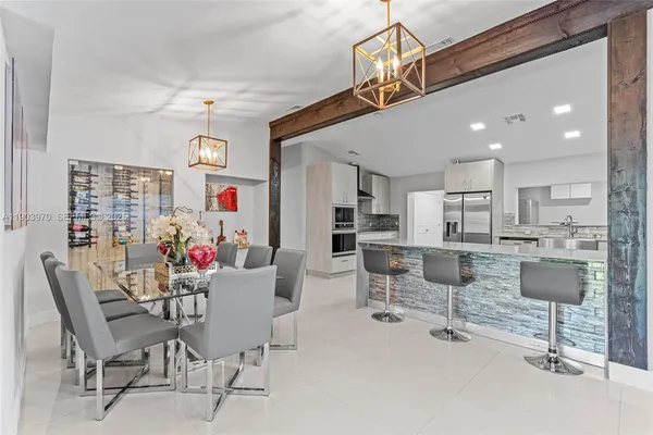 a dining room with furniture and a view of kitchen