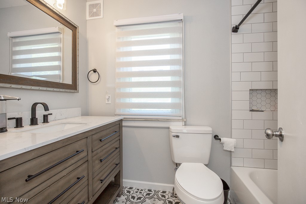 21825 Rye Road Beachwood, OH 44122 - Photo 17 of 35 Full bathroom with tiled shower / bath combo, vanity, toilet, and tile flooring