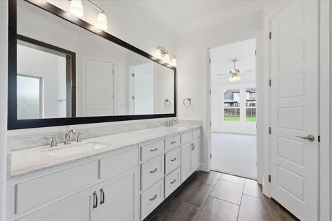 a bathroom with a double vanity sink and mirror