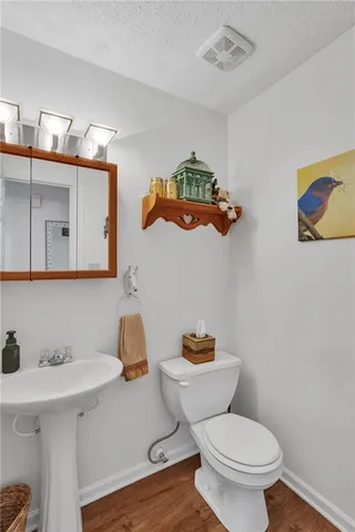 a bathroom with a sink a toilet and mirror