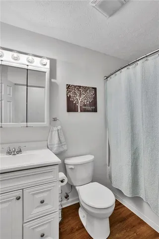 a bathroom with a toilet a sink and a mirror