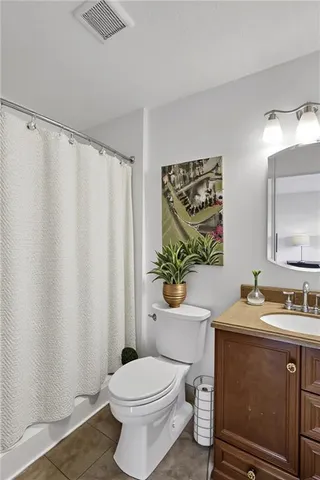 a bathroom with a sink toilet and mirror