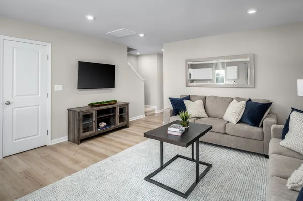 a living room with furniture a fireplace and a flat screen tv