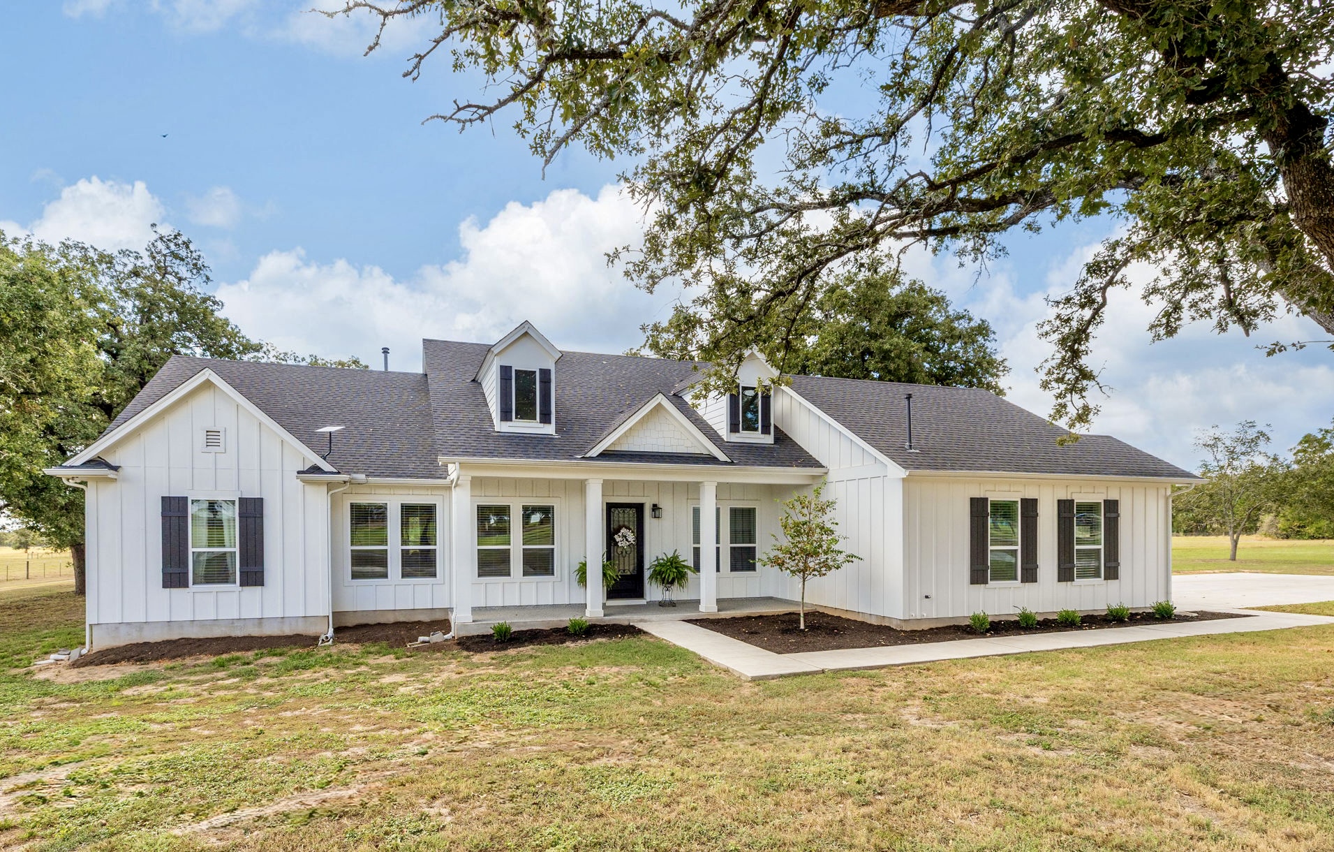 a view of a house with a swimming pool and a yard
