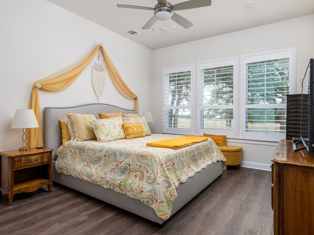 1145 West County Road East Lexington, TX 78947 - Photo 12 of 34 a bed sitting in a bedroom next to a window