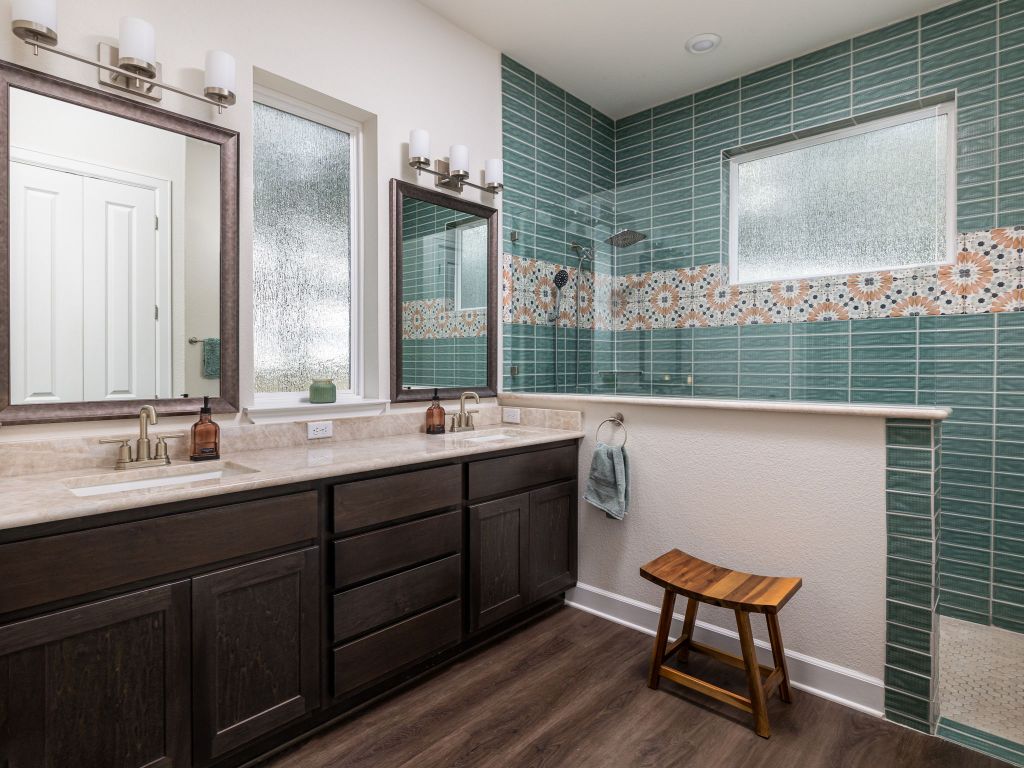 1145 West County Road East Lexington, TX 78947 - Photo 14 of 34 a bathroom with a double vanity sink and a mirror