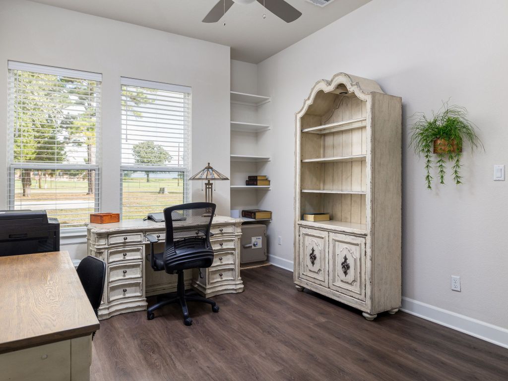 1145 West County Road East Lexington, TX 78947 - Photo 19 of 34 a view of a workspace with furniture and a window