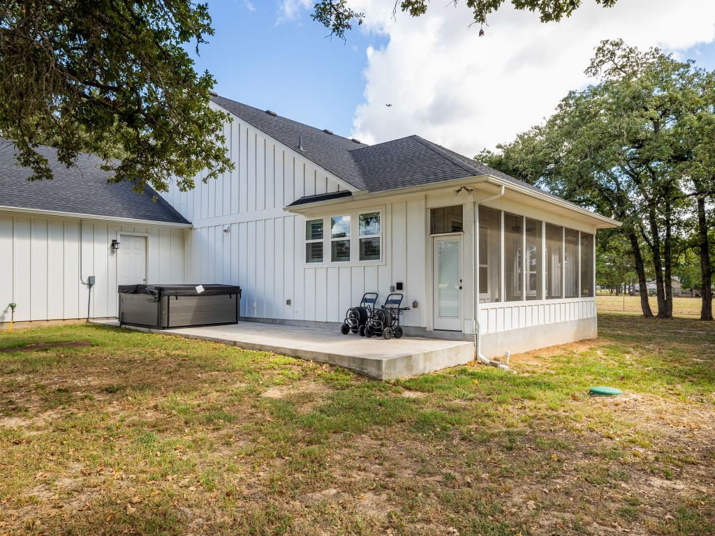 1145 West County Road East Lexington, TX 78947 - Photo 25 of 34 a view of a house with a yard and large tree