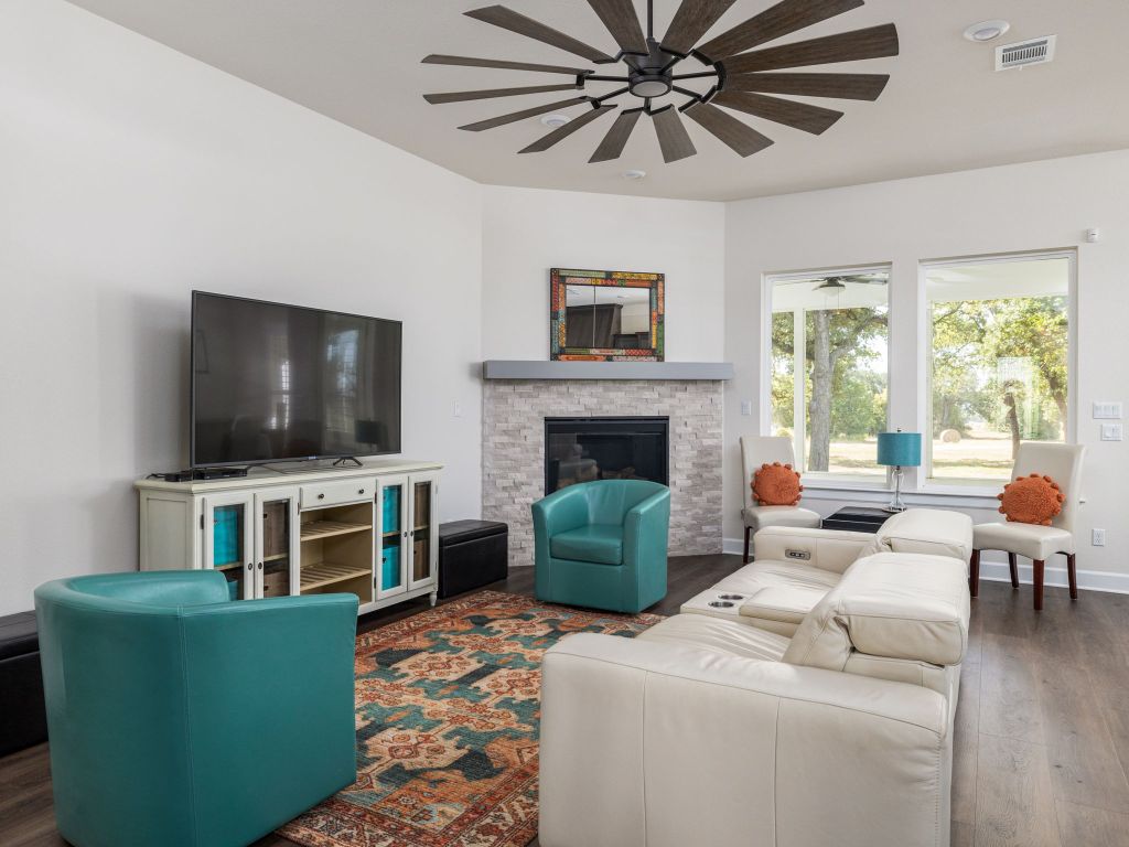 1145 West County Road East Lexington, TX 78947 - Photo 5 of 34 a living room with furniture and a flat screen tv