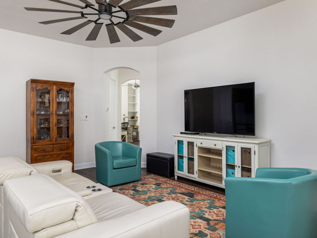 1145 West County Road East Lexington, TX 78947 - Photo 6 of 34 a living room with furniture and a flat screen tv