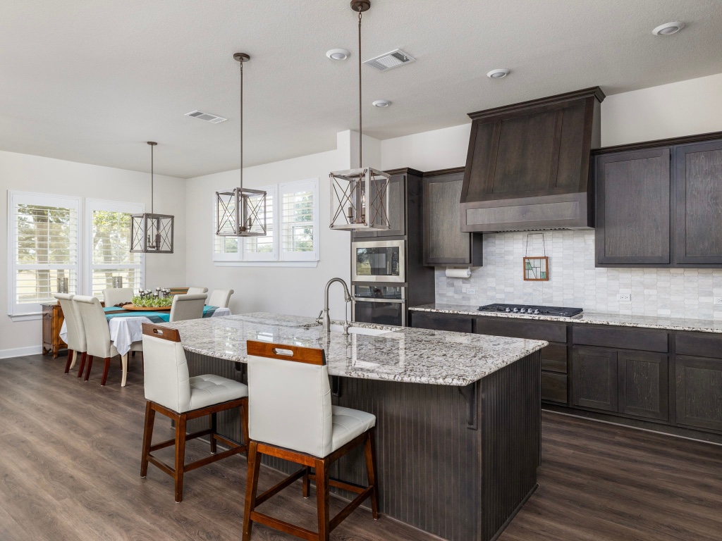 1145 West County Road East Lexington, TX 78947 - Photo 8 of 34 a kitchen with a dining table chairs sink and cabinets