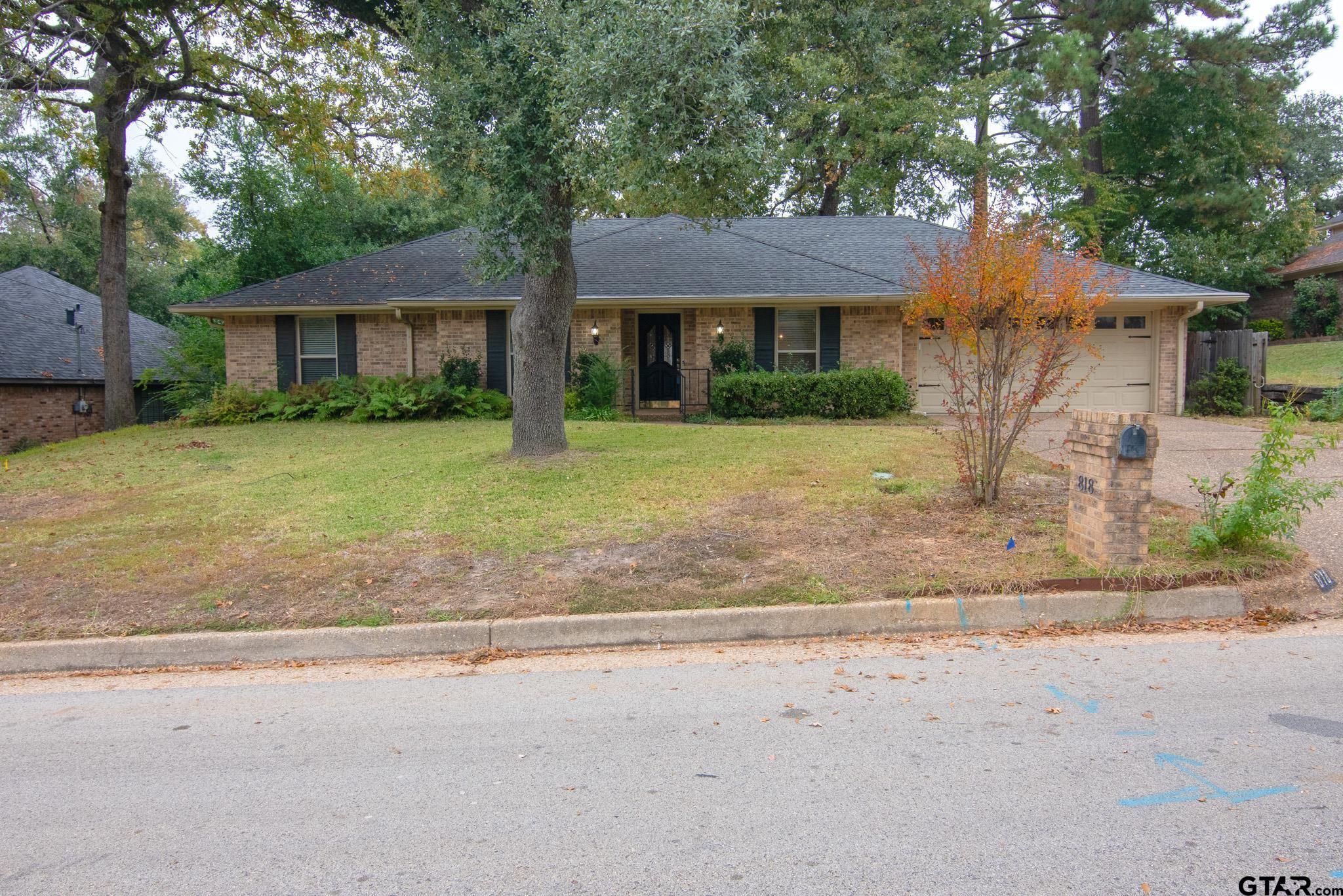 818 Beth Drive Tyler, TX 75703 - Photo 24 of 24 a front view of a house with a yard and a garage