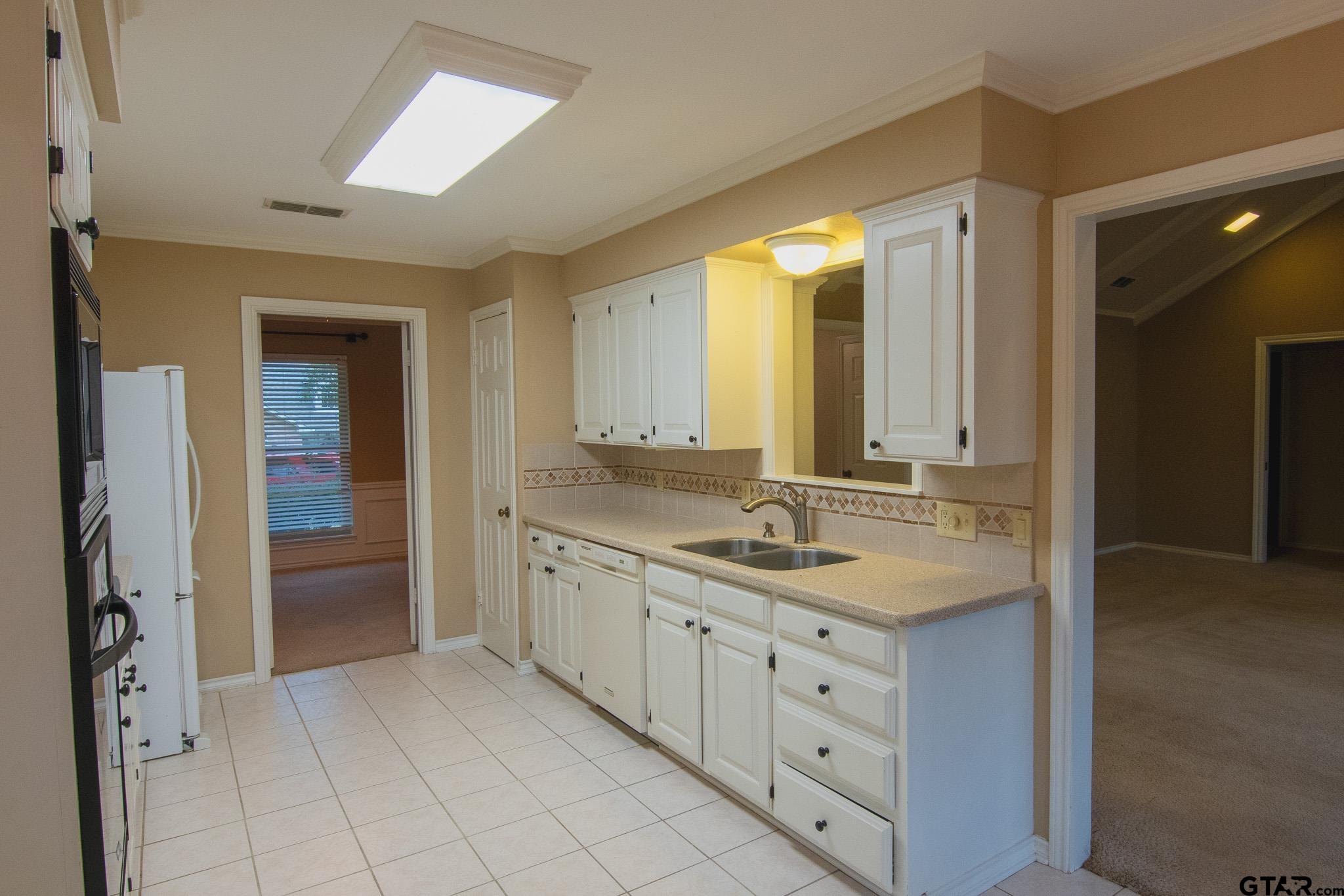 818 Beth Drive Tyler, TX 75703 - Photo 6 of 24 a spacious bathroom with a granite countertop sink and a mirror