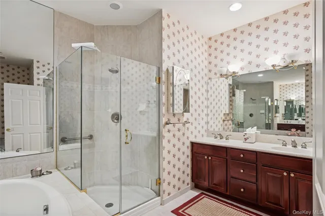 a bathroom with a double vanity sink mirror and shower
