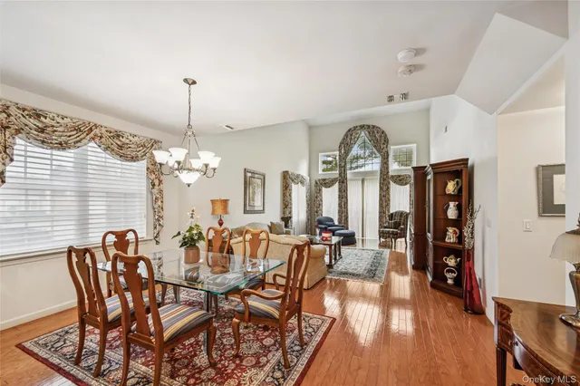 a view of a dining room with furniture wooden floor and chandelier