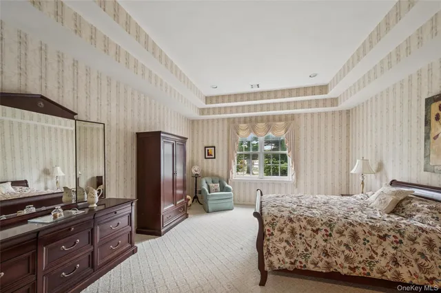 a bedroom with a bed dresser and a window