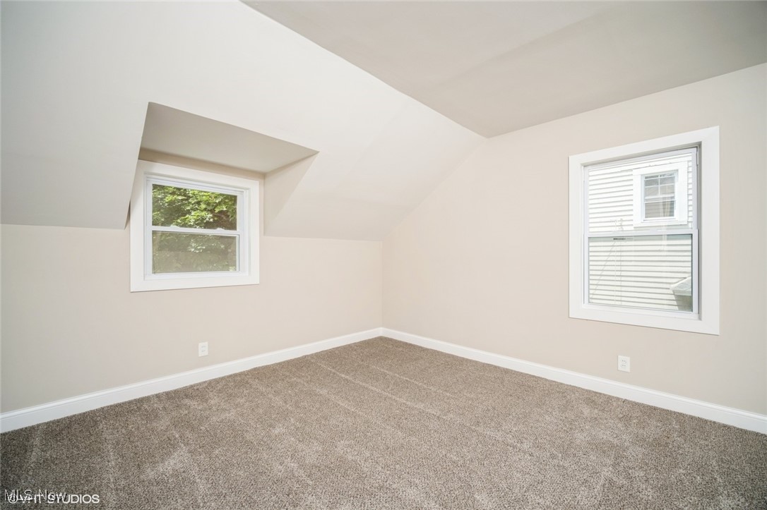 2188 North Taylor Road Cleveland Heights, OH 44112 - Photo 8 of 15 Additional living space with carpet and vaulted ceiling