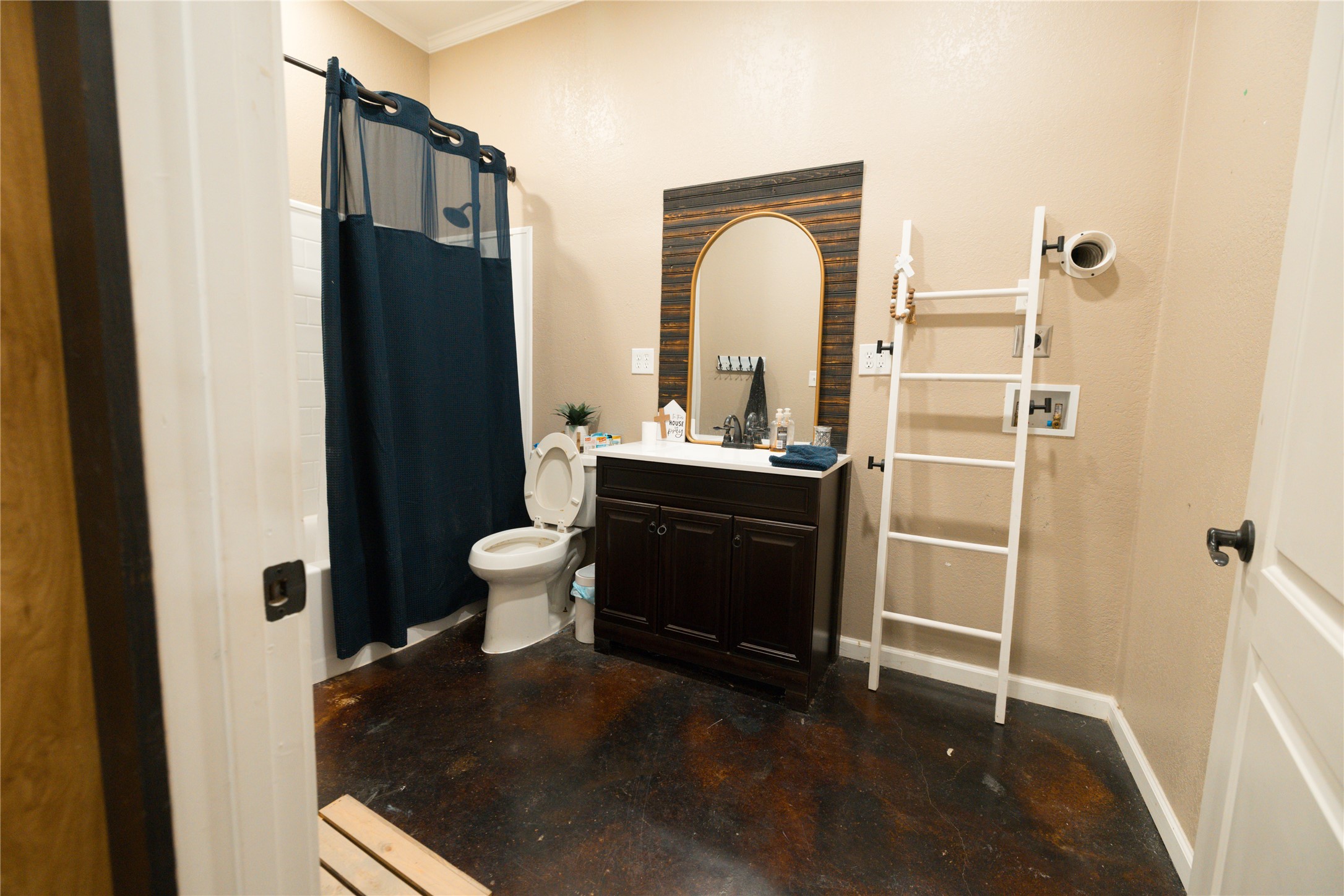 143 County Road Paige, TX 78659 - Photo 31 of 36 Guest house Bathroom with vanity, concrete flooring, shower / bath combination with curtain, and ornamental molding