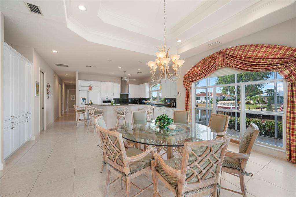 1030 Conecta Drive Punta Gorda, FL 33950 - Photo 15 of 74 a dining room with furniture a chandelier and kitchen view