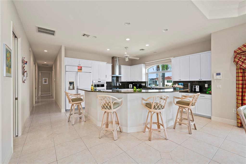 1030 Conecta Drive Punta Gorda, FL 33950 - Photo 16 of 74 a kitchen with stainless steel appliances granite countertop a table and chairs in it