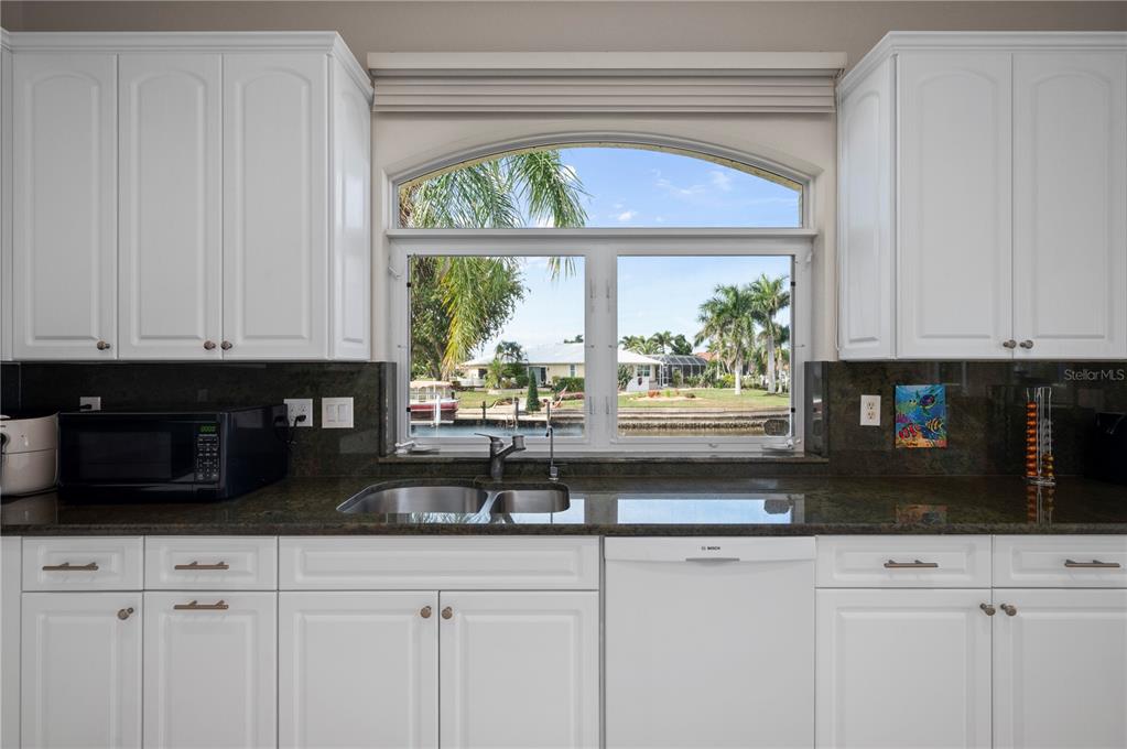 1030 Conecta Drive Punta Gorda, FL 33950 - Photo 18 of 74 a kitchen with stainless steel appliances white cabinets and a granite counter tops