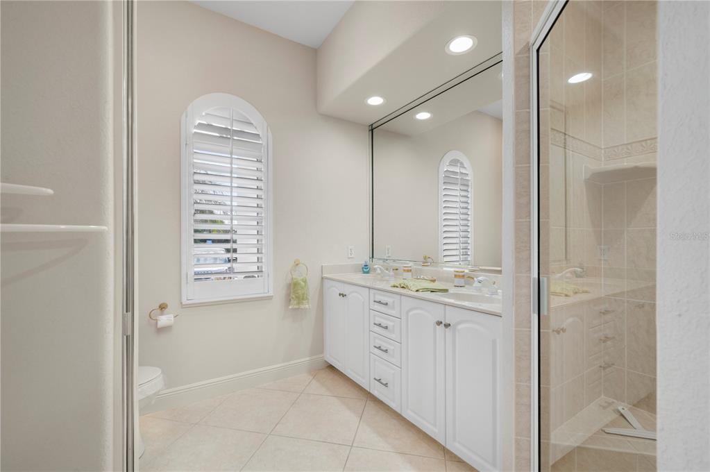 1030 Conecta Drive Punta Gorda, FL 33950 - Photo 32 of 74 a bathroom with a granite countertop sink a mirror and a bathtub