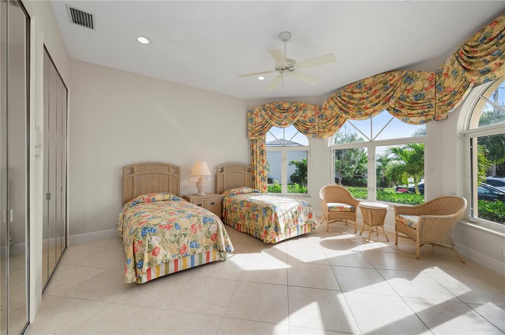 1030 Conecta Drive Punta Gorda, FL 33950 - Photo 34 of 74 a spacious bedroom with two beds and large windows
