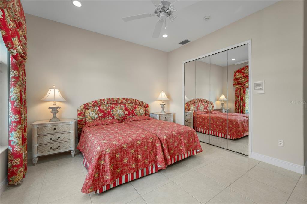 1030 Conecta Drive Punta Gorda, FL 33950 - Photo 39 of 74 a bedroom with two beds and a chandelier