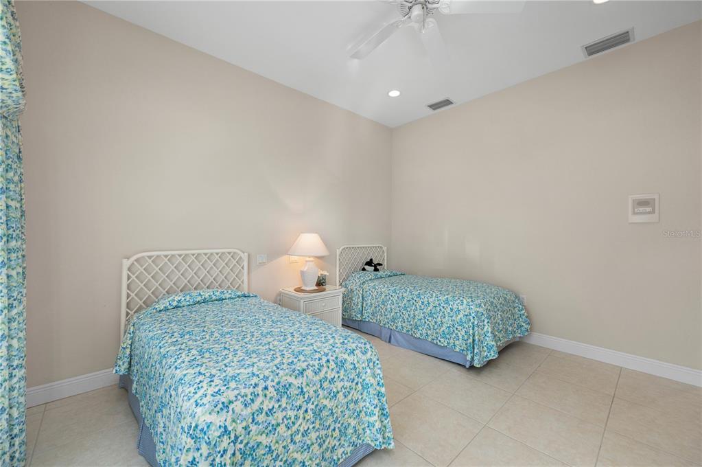 1030 Conecta Drive Punta Gorda, FL 33950 - Photo 47 of 74 a bedroom with two beds and a chandelier