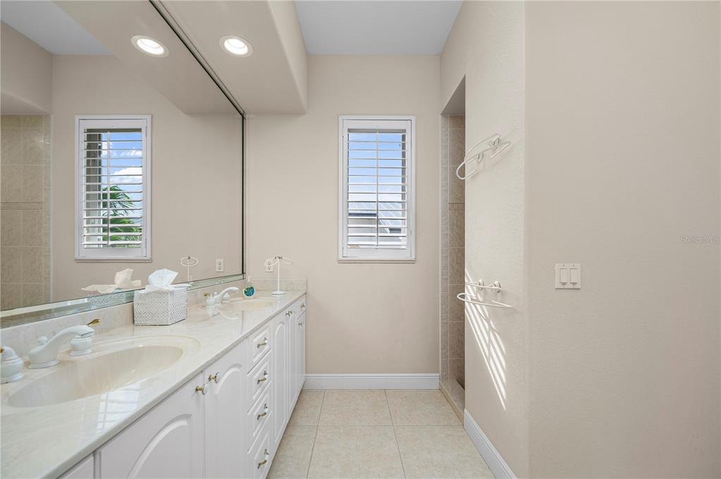 1030 Conecta Drive Punta Gorda, FL 33950 - Photo 49 of 74 a spacious bathroom with double vanity and a mirror