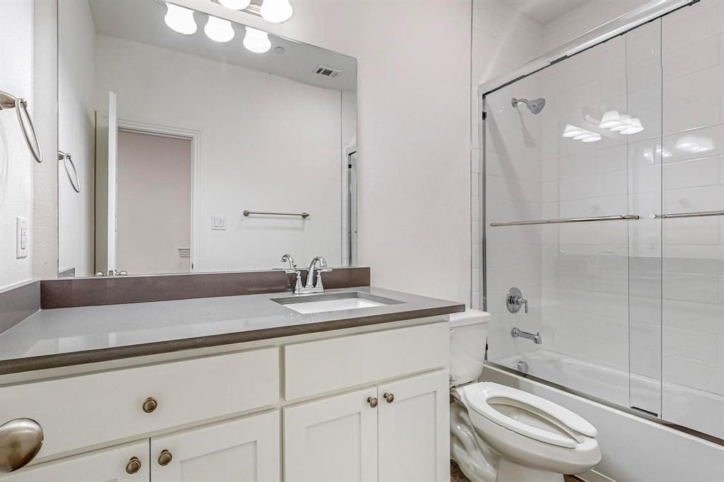 336 Buck Ridge Drive Frisco, TX 75068 - Photo 14 of 40 a bathroom with a granite countertop sink toilet a mirror and shower