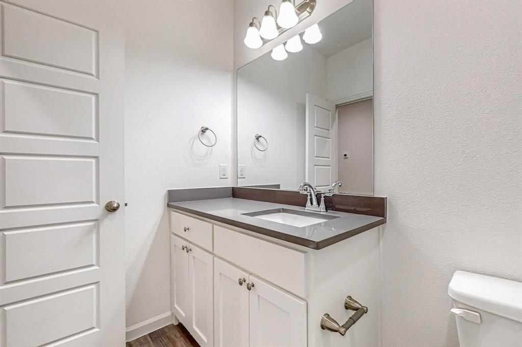 336 Buck Ridge Drive Frisco, TX 75068 - Photo 15 of 40 a bathroom with a granite countertop sink and a mirror