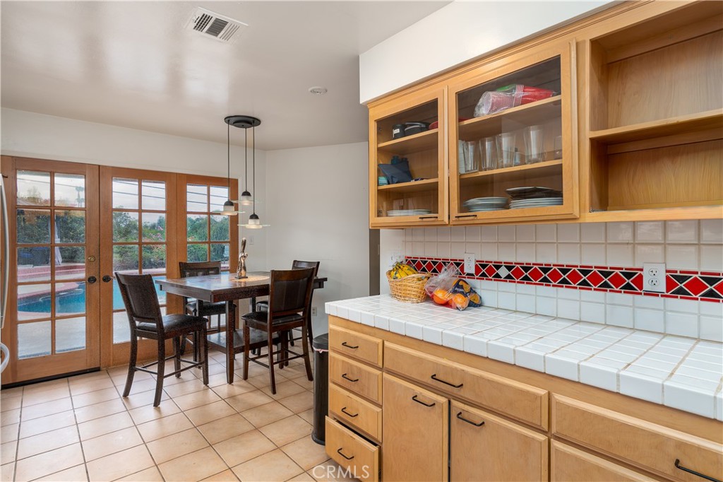 4967 Chapala Drive Riverside, CA 92507 - Photo 18 of 34 a kitchen with a cabinets and chairs in it