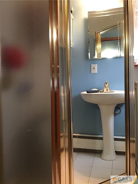 24 Latonia Street Edison, NJ 08817 - Photo 3 of 7 a bathroom with a sink a mirror and next to a window