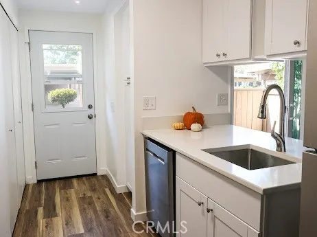 a kitchen with a sink and cabinets