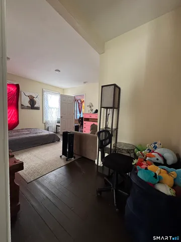 a bedroom with furniture and a window