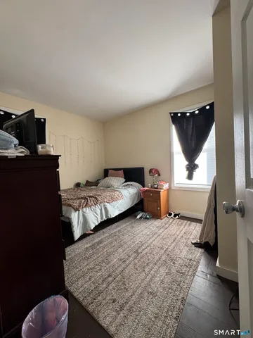 a bedroom with bed and window