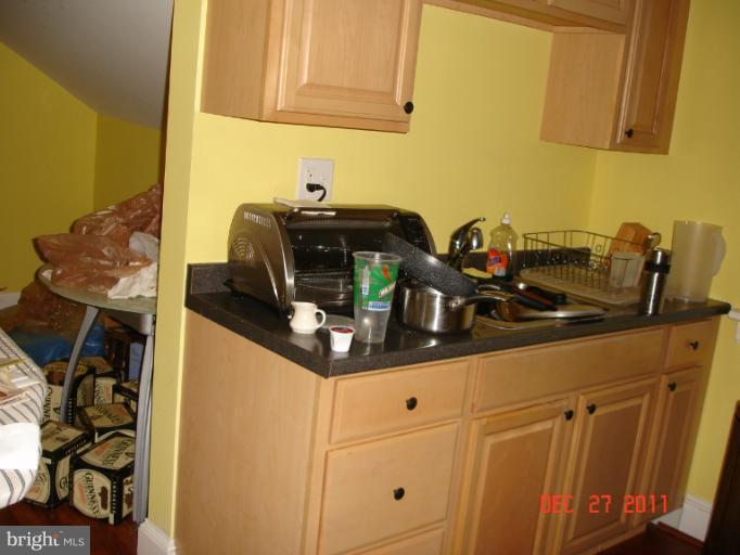 4511 Powder Mill Road Beltsville, MD 20705 - Photo 12 of 13 a kitchen with a sink and cabinets