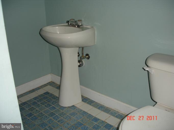 4511 Powder Mill Road Beltsville, MD 20705 - Photo 5 of 13 a bathroom with a sink a toilet and a shower