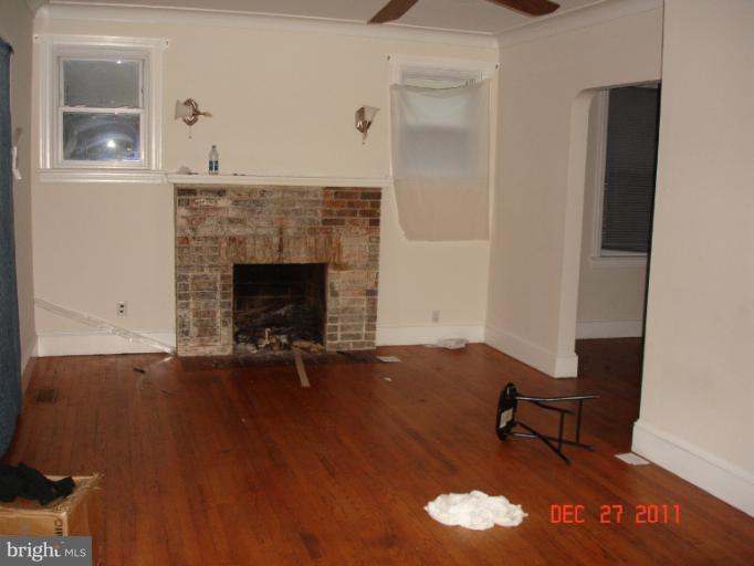 4511 Powder Mill Road Beltsville, MD 20705 - Photo 8 of 13 a living room with furniture and a fireplace