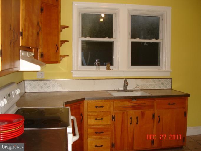 4511 Powder Mill Road Beltsville, MD 20705 - Photo 9 of 13 a bathroom with a sink and a mirror