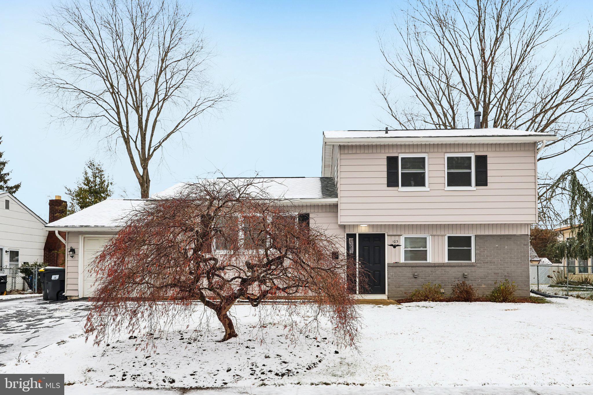 103 Anglin Drive Newark, DE 19713 - Photo 1 of 25 a front view of a house with a yard covered in snow