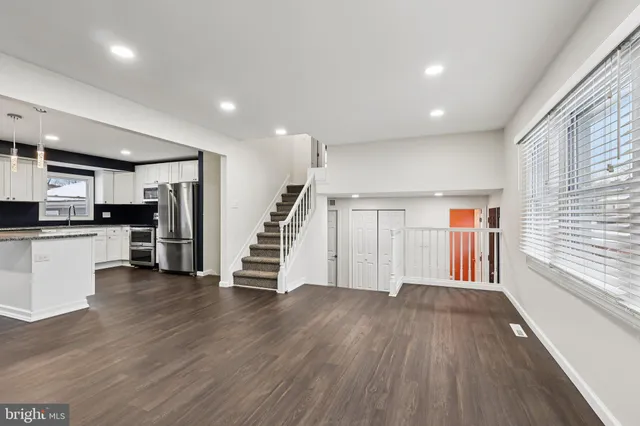 a view of a kitchen with wooden floor and electronic appliances