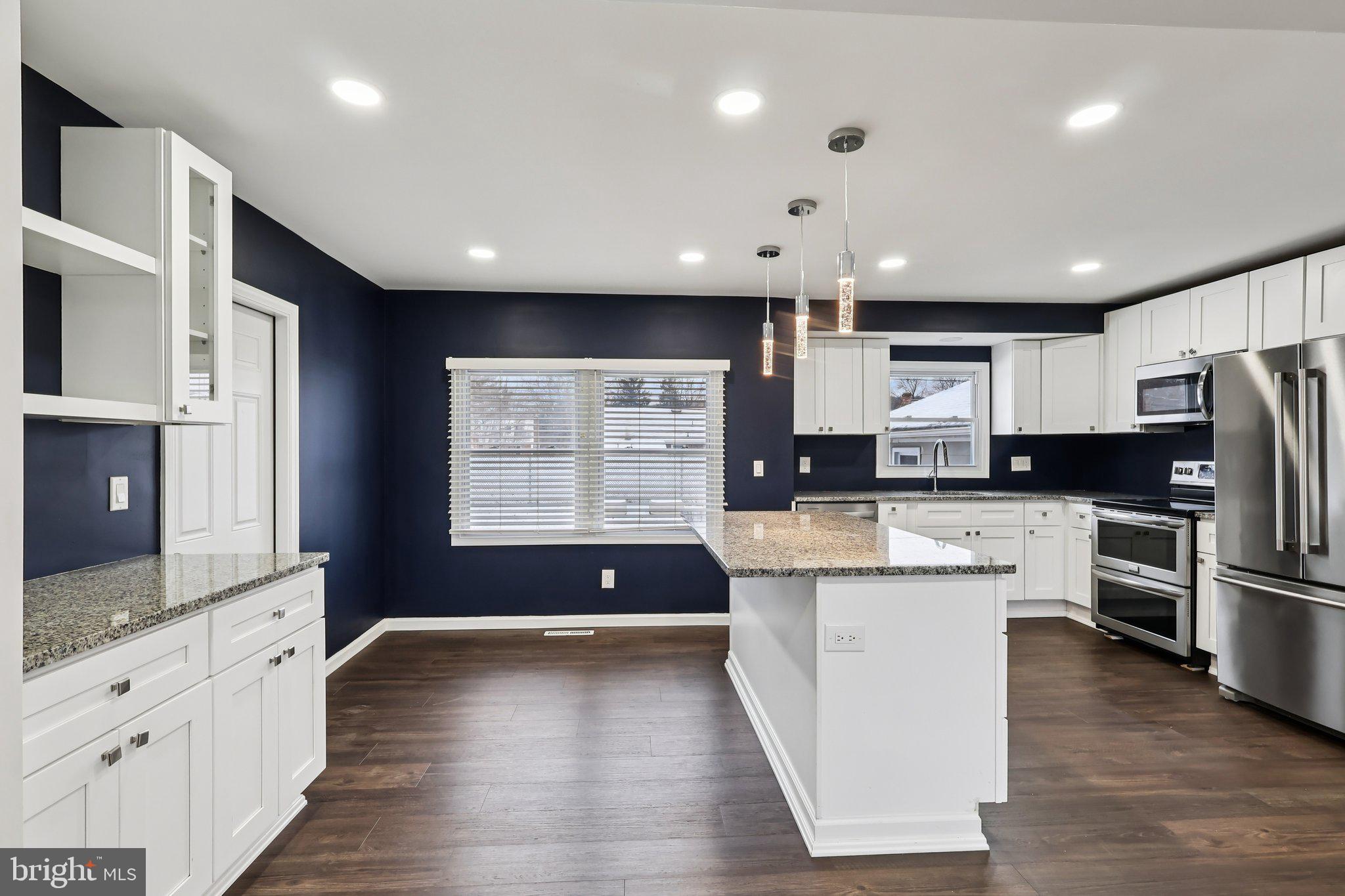 103 Anglin Drive Newark, DE 19713 - Photo 12 of 25 a kitchen with stainless steel appliances granite countertop a refrigerator a sink dishwasher a oven and a large island with wooden floor