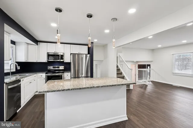 a large kitchen with stainless steel appliances lots of counter top space