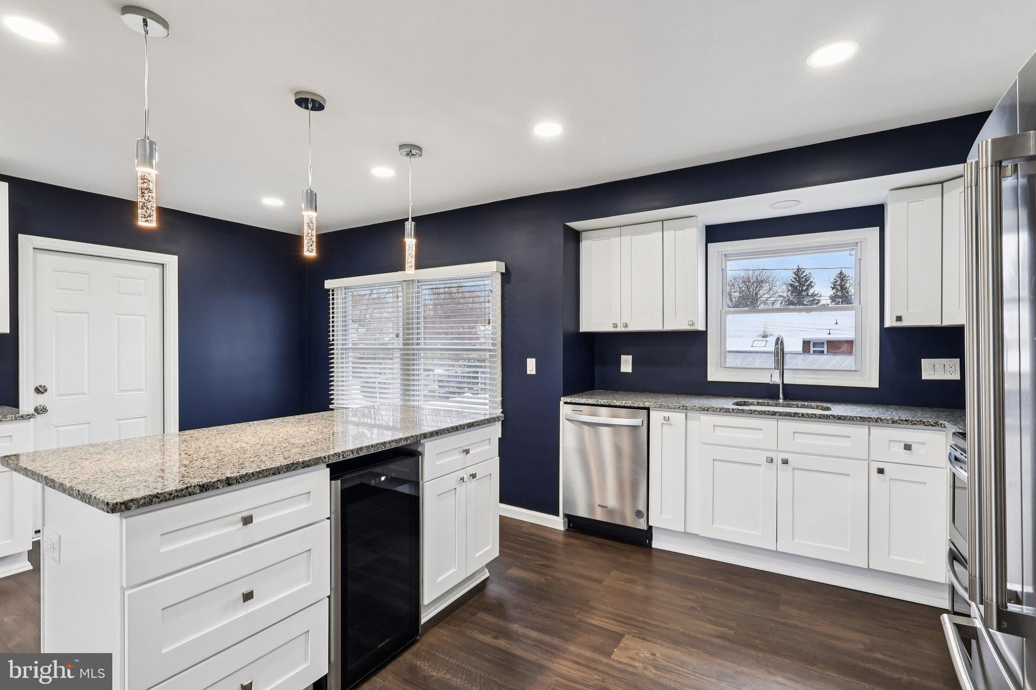 103 Anglin Drive Newark, DE 19713 - Photo 15 of 25 a large kitchen with granite countertop a sink stainless steel appliances and cabinets