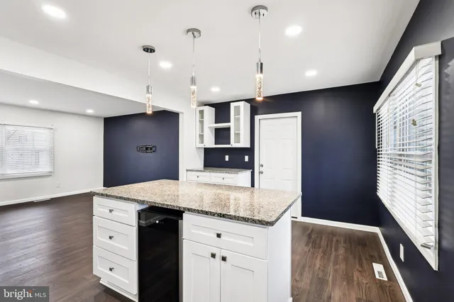 a kitchen with a sink a counter space and appliances