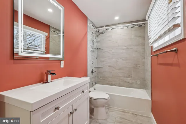 a bathroom with a shower toilet sink and mirror